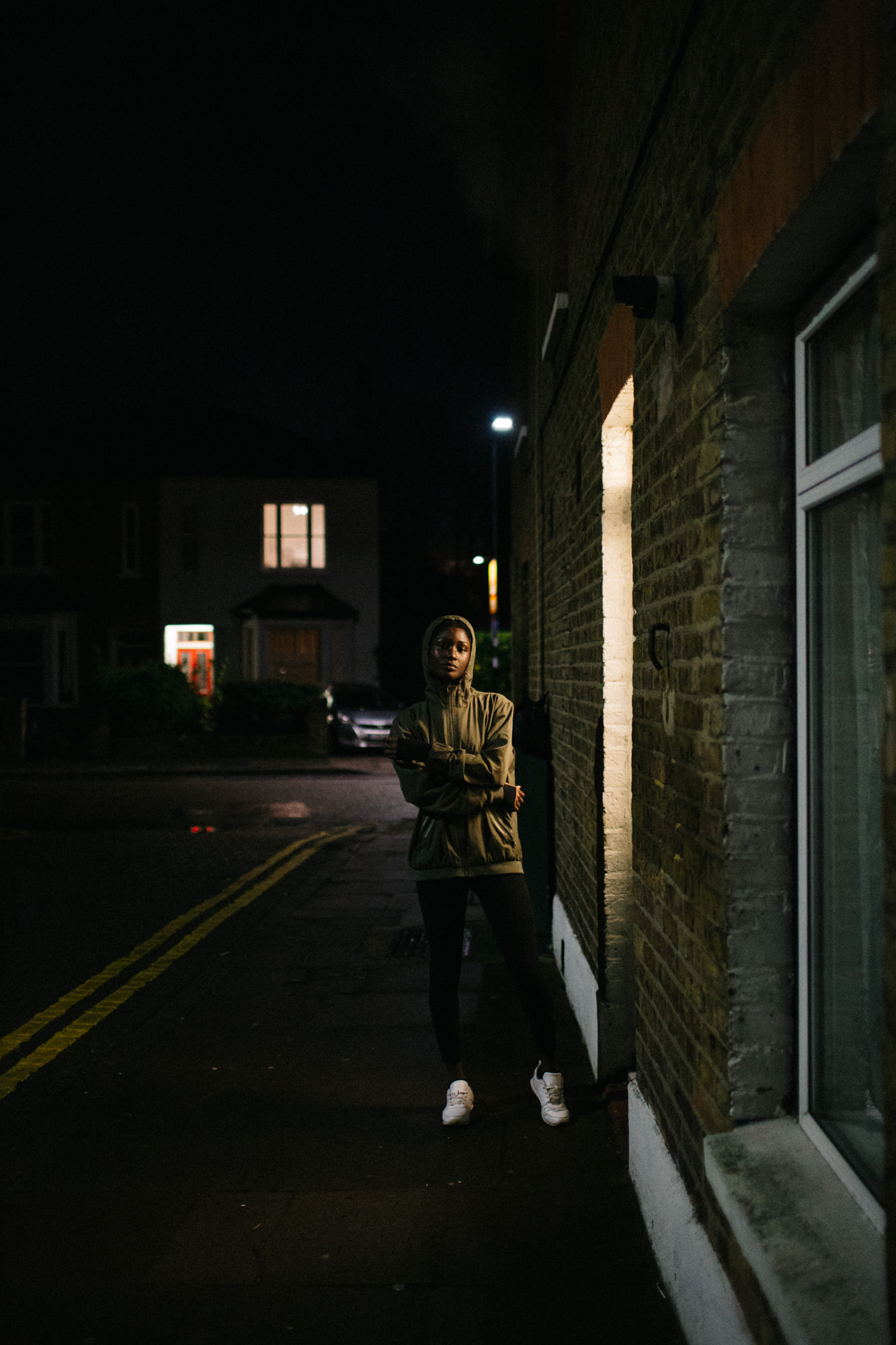 Young ethnic woman on street at night