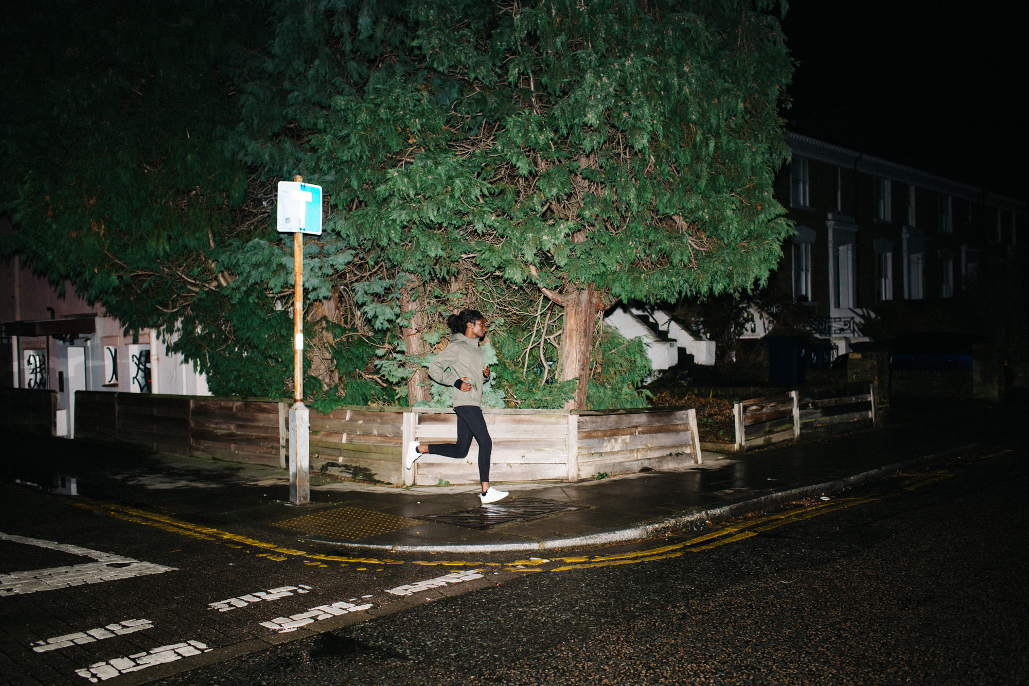 Young woman running on street