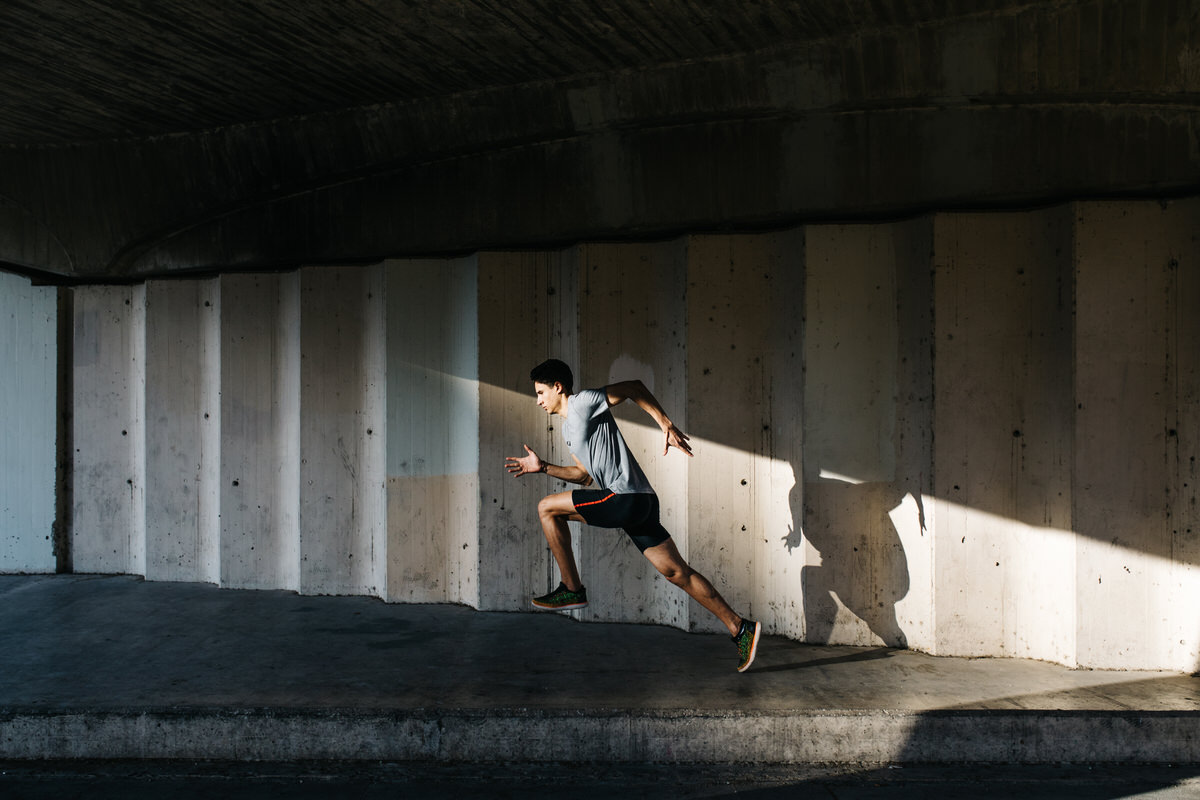 Sportsman running under bridge