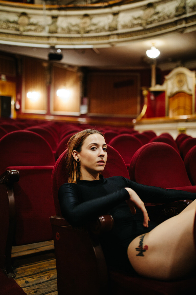 Dancer resting in auditorium