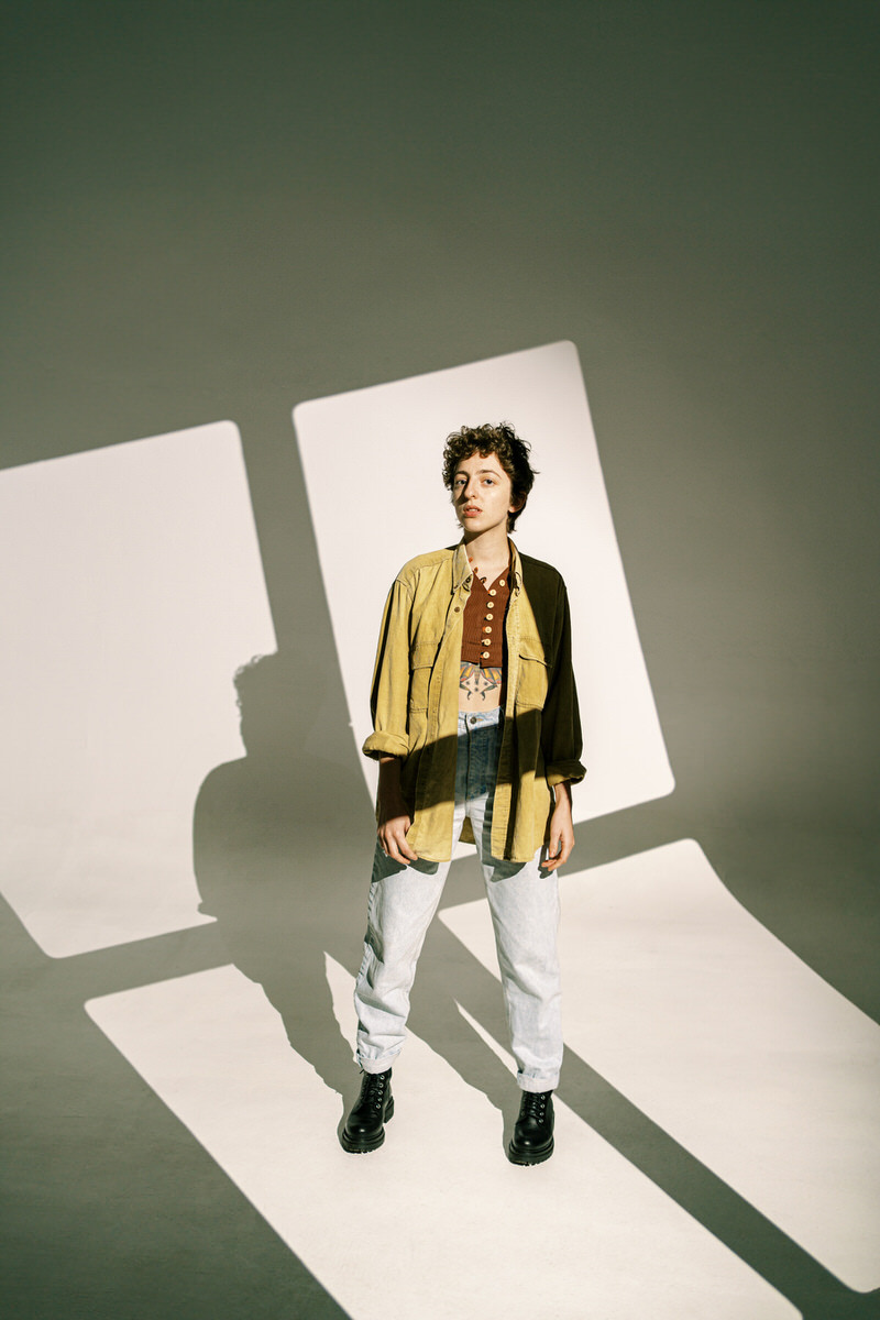 Androgynous model in shadow of window