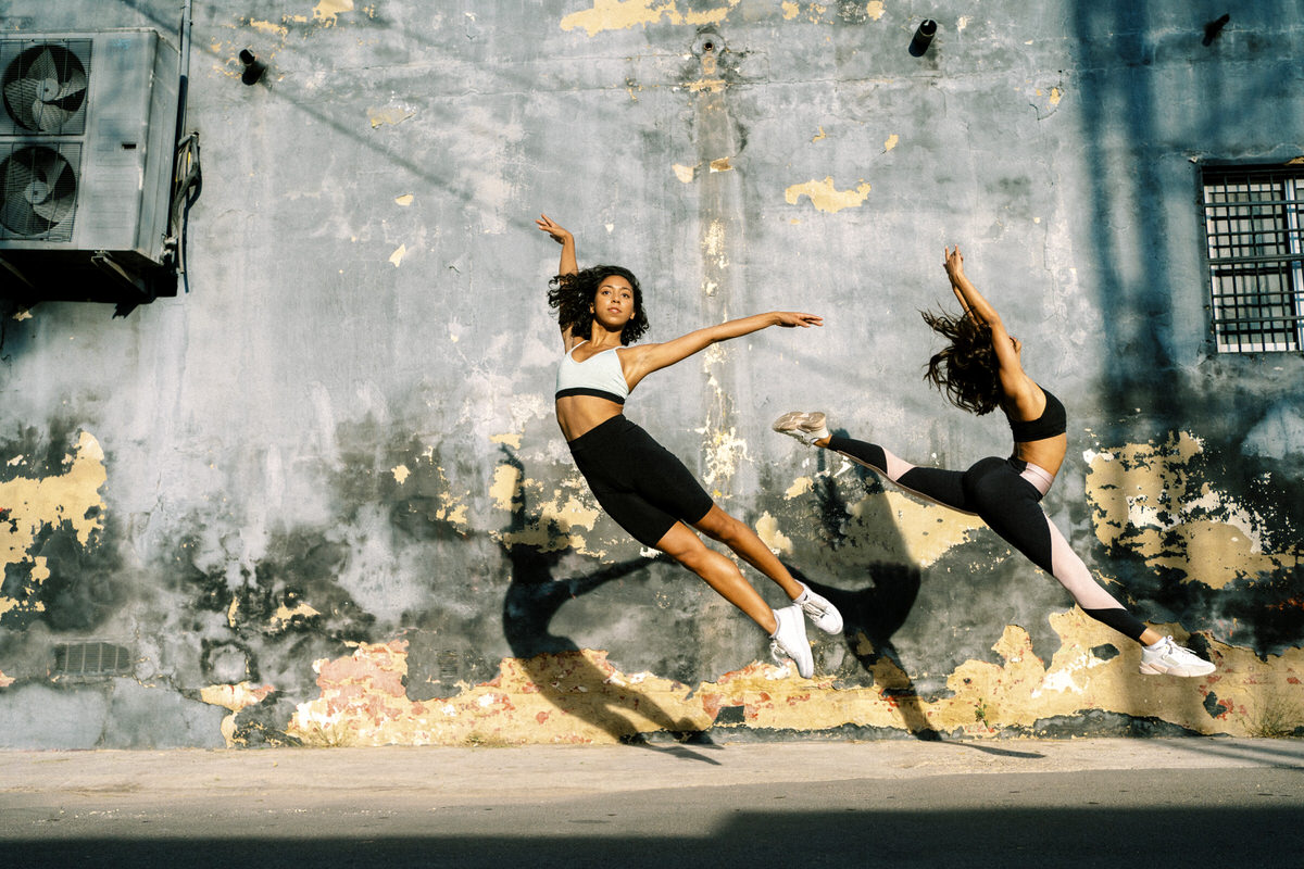 Fit women dancing on street