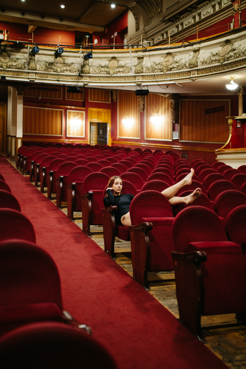 Dancer resting in auditorium