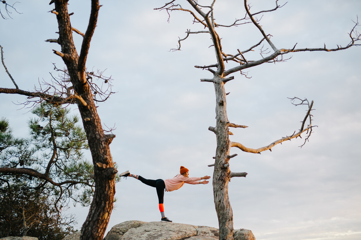 Woman stretching on hill