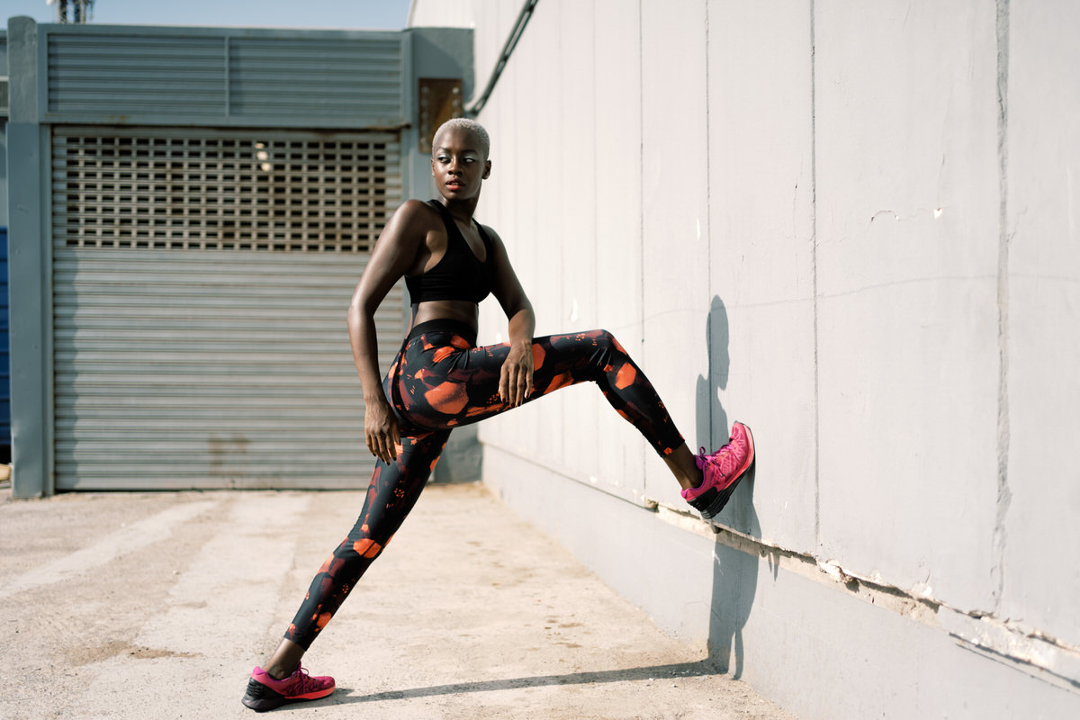 Fit sportswoman exercising near wall