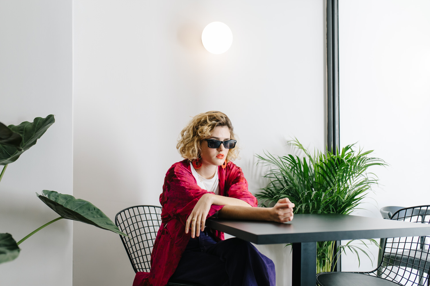 Trendy woman at cafe table