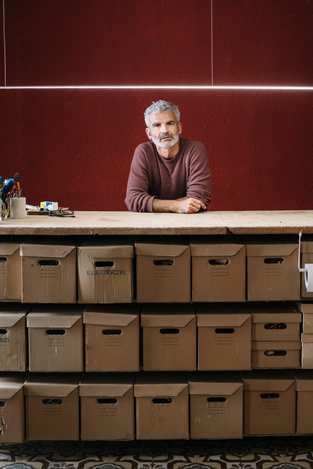 Mature man behind counter in workshop