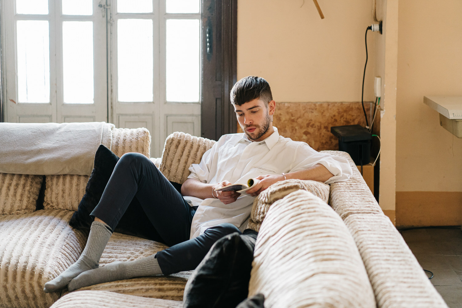 Young man reading on sofa