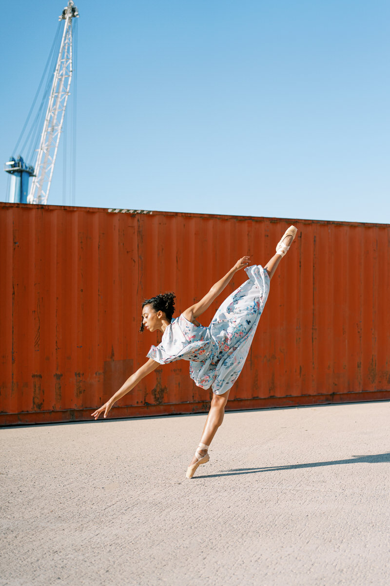 Elegant ballerina in summer dress standing on tiptoe