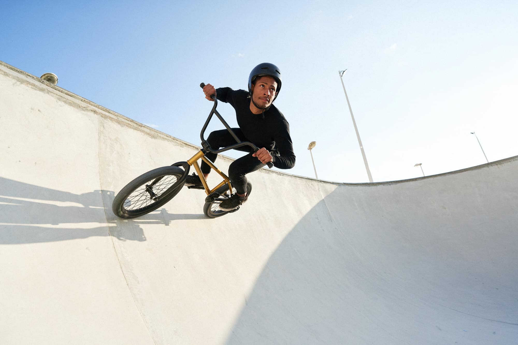 Black man riding bicycle in skate park