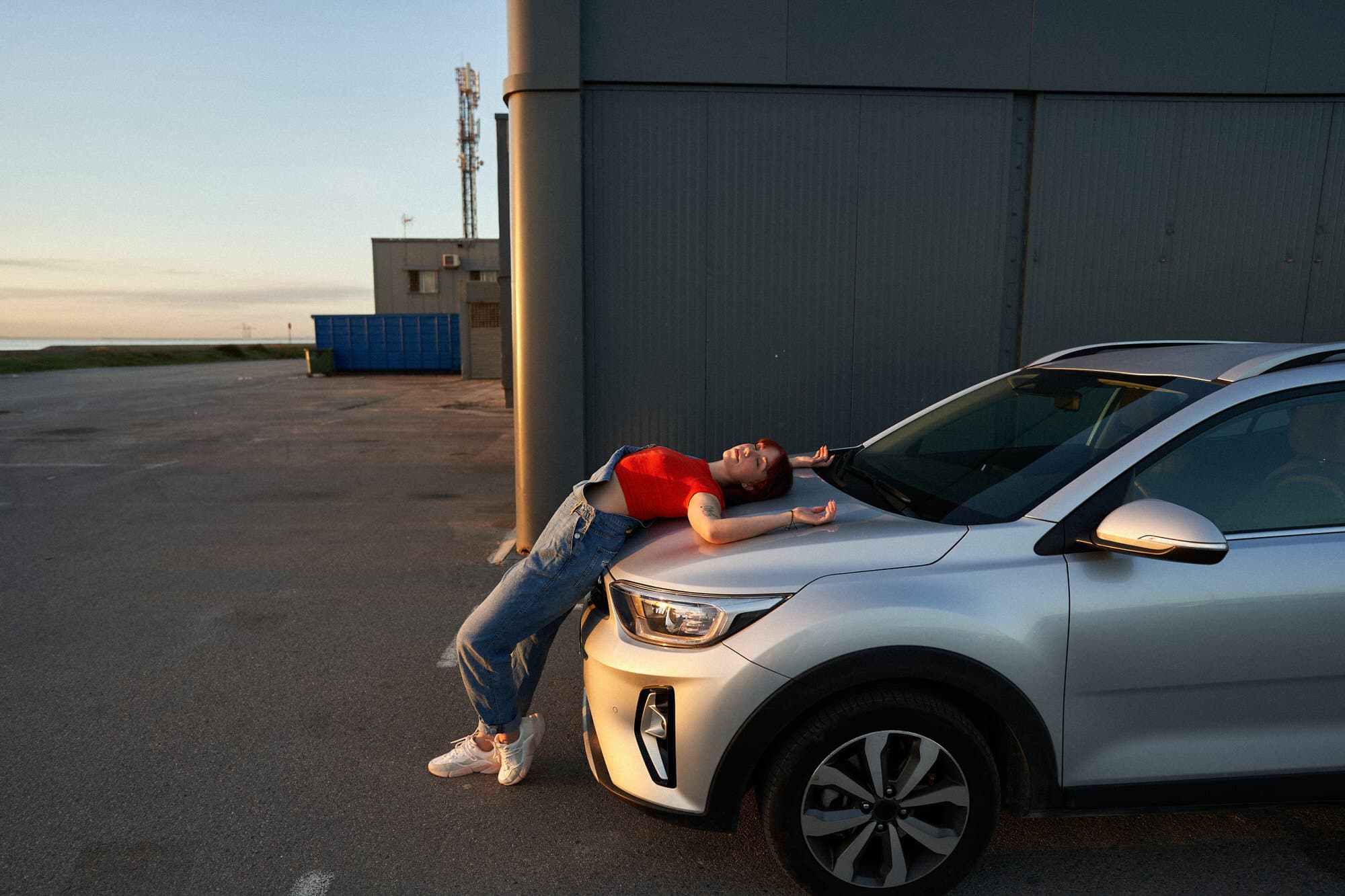 Trendy woman near modern car